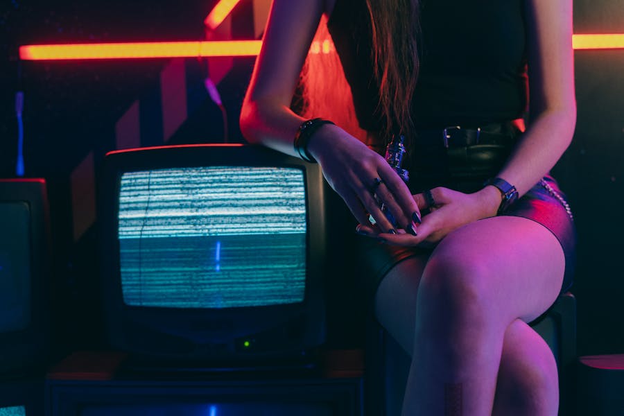 a girl sitting next to a tv